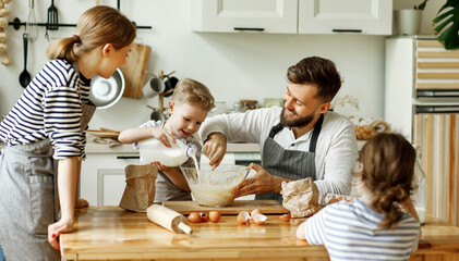 Happy family enjoying cooking together.