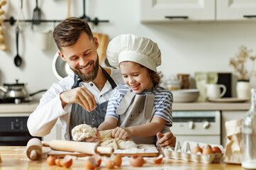 Father and daughter making pastry together.