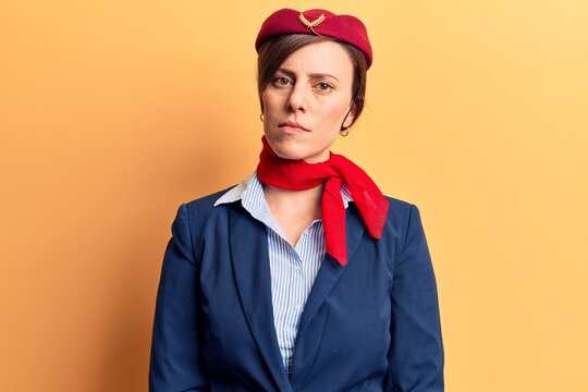 Young Beautiful Woman Wearing Stewardess Uniform Relaxed With Serious Expression On Face. Simple And Natural Looking At The Camera.