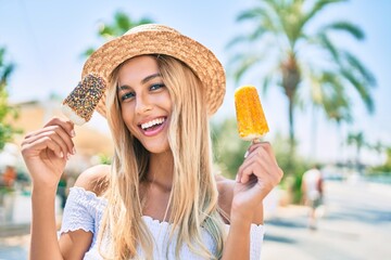 Young blonde tourist girl smiling happy eating ice cream at the city.