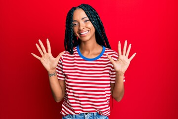 Beautiful hispanic woman wearing casual clothes showing and pointing up with fingers number ten while smiling confident and happy. - obrazy, fototapety, plakaty