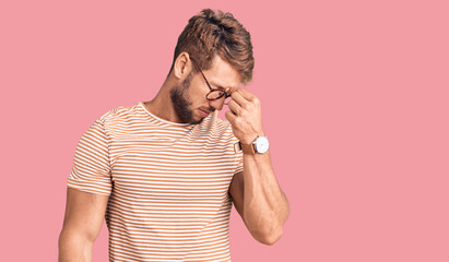 Young caucasian man wearing casual clothes and glasses tired rubbing nose and eyes feeling fatigue...