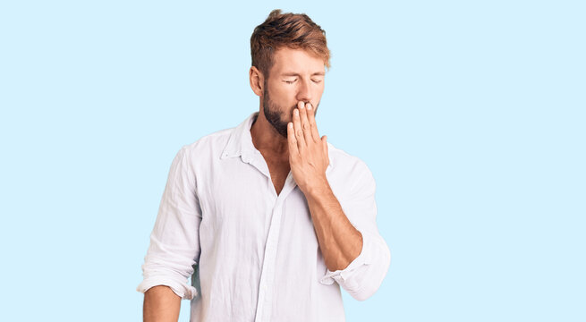 Young caucasian man wearing casual clothes bored yawning tired covering mouth with hand. restless and sleepiness.