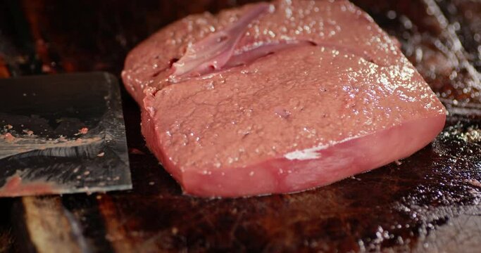 Fresh raw liver on a cutting board. 