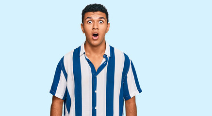 Young arab man wearing casual clothes afraid and shocked with surprise expression, fear and excited face.
