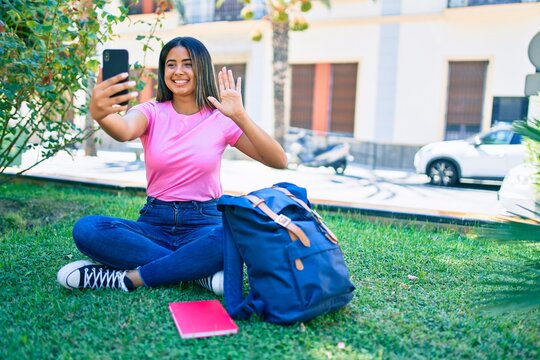 Young latin student girl smiling happy doing video call using smartphone at university campus.