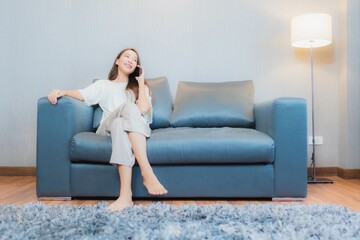 Portrait beautiful young asian woman use smart mobile phone on sofa