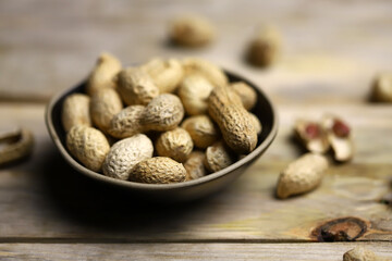 Peanuts in a peel in a bowl. Selective focus. Macro.