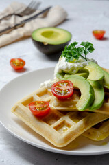 Vegan waffles with avocado with yogurt and cherry
