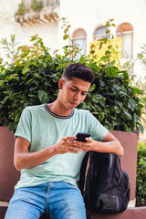 Obraz premium portrait of man sitting with cell phone waiting with briefcase
