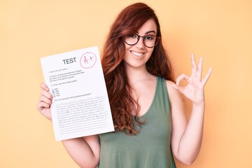 Young beautiful woman showing a passed exam doing ok sign with fingers, smiling friendly gesturing excellent symbol