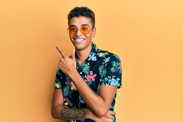 Young handsome african american man wearing summer style smiling cheerful pointing with hand and finger up to the side