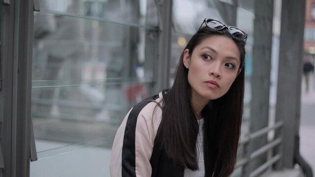 Pretty Asian girl in a city - close up shot - people photography