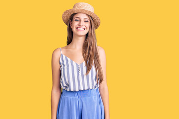 Young beautiful blonde woman wearing summer hat with a happy and cool smile on face. lucky person.