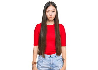 Young chinese woman wearing casual clothes depressed and worry for distress, crying angry and afraid. sad expression.