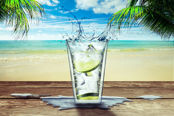 One glass with lemonade on a wooden bar table on a tropical beach
