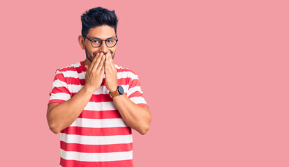 Handsome latin american young man wearing casual clothes and glasses laughing and embarrassed...