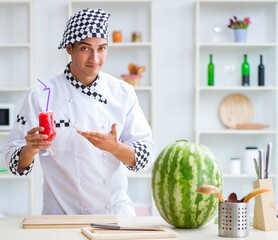 Male cook with watermelon in kitchen