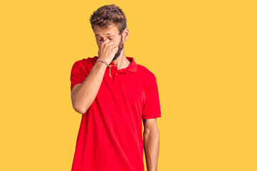 Handsome blond man with beard wearing casual clothes tired rubbing nose and eyes feeling fatigue...