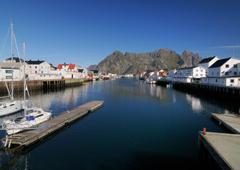 Fototapeta na wymiar Harbour Of the Small Fishing Village Henningsvaer On Lofoten Island Austvagoy On A Sunny Summer Day With A Clear Blue Sky