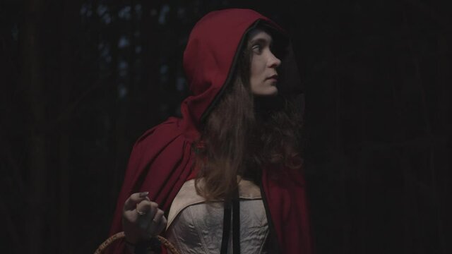Red riding hood in dark woods, slow motion
