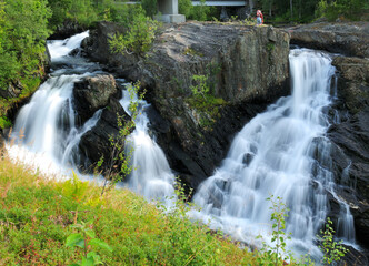 Long Time Exposure Of Baggfossen Falls aka Kebbelvfossen At Leirfjord In Norway On A Sunny Summer Day