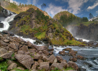 Latefossen Falls Flowing Into The Gronsdalslona River On A Cloudy Summer Day