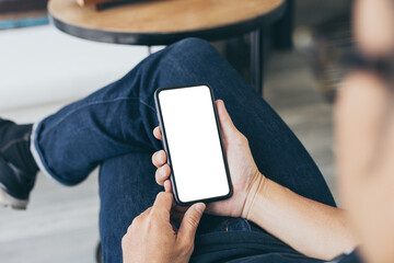 cell phone mockup blank white screen.woman hand holding texting using mobile on desk at coffee shop.background empty space for advertise.work people contact marketing business,technology