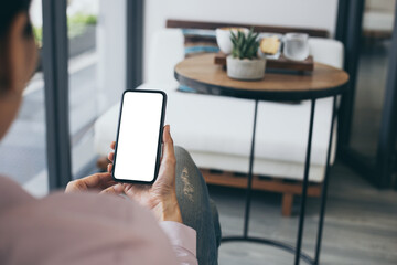 cell phone mockup blank white screen.woman hand holding texting using mobile on desk at coffee shop.background empty space for advertise.work people contact marketing business,technology