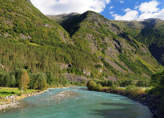 Beautiful Wild River Jostedola In Jostedalsbreen National Park On A Sunny Summer Day With A Clear Blue Sky And A Few Clouds