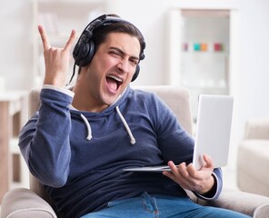 Young handsome man listening to music with headphones