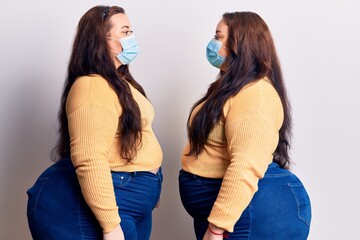 Young plus size twins wearing medical mask looking to side, relax profile pose with natural face with confident smile.