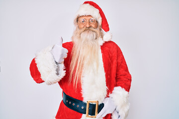 Old senior man with grey hair and long beard wearing santa claus costume smiling happy and positive, thumb up doing excellent and approval sign