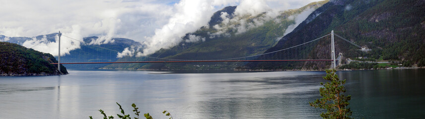 Panorama View To The Hardangerbrua Suspension Bridge At Eidfjord On An Overcast  Summer Day