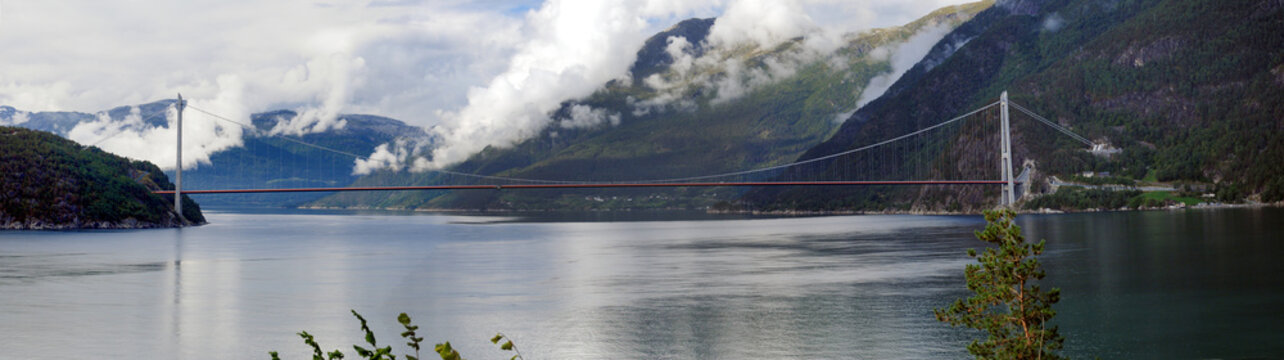 Panorama View To The Hardangerbrua Suspension Bridge At Eidfjord On An Overcast  Summer Day