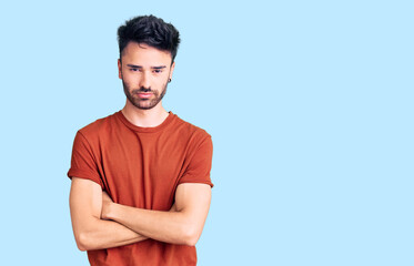 Young hispanic man wearing casual clothes skeptic and nervous, disapproving expression on face with...