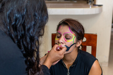 woman putting makeup on another woman