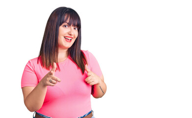 Young plus size woman wearing casual clothes pointing fingers to camera with happy and funny face. good energy and vibes.