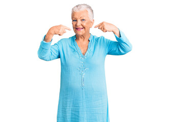 Senior beautiful woman with blue eyes and grey hair wearing summer dress smiling cheerful showing and pointing with fingers teeth and mouth. dental health concept.