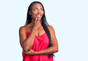 Young african american woman wearing casual clothes with hand on chin thinking about question, pensive expression. smiling with thoughtful face. doubt concept.