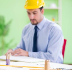 Young male architect working at the project
