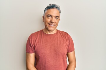 Handsome middle age mature man wearing casual clothes with a happy and cool smile on face. lucky...