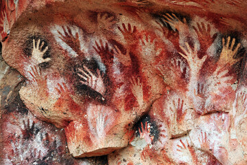 Naklejka na ściany i meble Paintings of hands, at the Cave of the Hands, an Ancient Cave Paintings in Patagonia 
