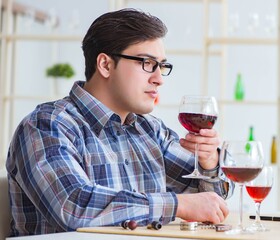Professional sommelier tasting red wine