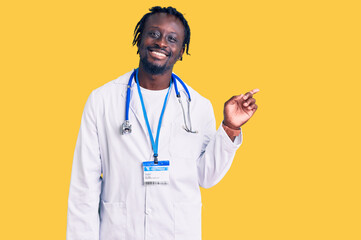 Young african american man with braids wearing doctor stethoscope and id pass smiling happy pointing with hand and finger to the side