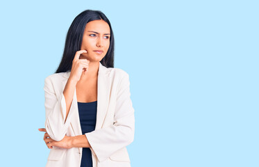 Young beautiful latin girl wearing business clothes serious face thinking about question with hand...