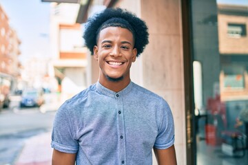 Young african american man smiling happy walking at the city.