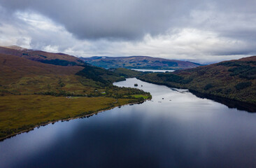 shot of loch arkaig in the argyll region of the highlands of scotland during autumn on a clear bright day showing calm waters on the inland loch