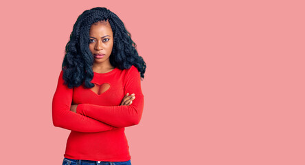 Beautiful african american woman wearing casual clothes skeptic and nervous, disapproving expression on face with crossed arms. negative person.