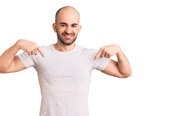 Young handsome man wearing casual t shirt looking confident with smile on face, pointing oneself with fingers proud and happy.